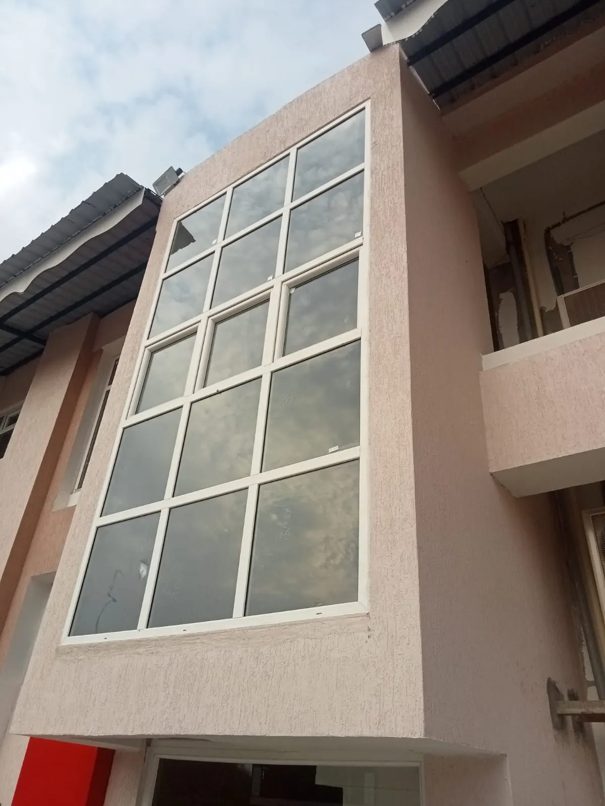 White uPVC glazed windows installed on a building facade in Lalitpur